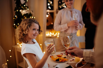 Family christmas toast by christmas table.