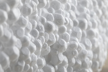 Macro shot of a piece of polystyrene foam. Extreme close-up view of the cross-section of a polystyrene part. Close-up view of a piece of styrofoam.