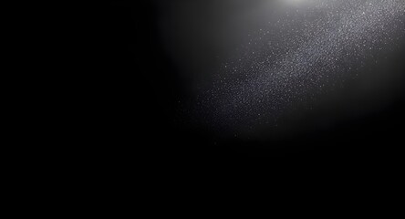 Fine silver sparkle dust forming elegant diagonal burst on clean deep black background