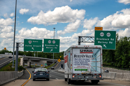 Dulles, USA - May 24, 2025: Sully road 28 highway in Northern Virginia with traffic cars U-haul truck and exit sign for Dulles International Airport