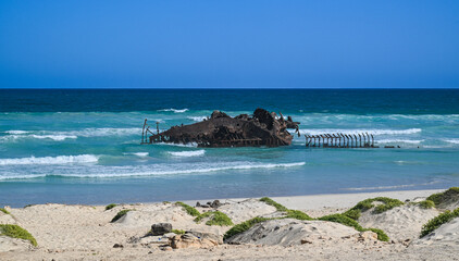 Rusty shipwreck on the turquoise shores of Boa Vista, Cape Verde