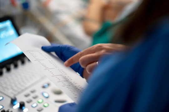 Medical professional analyzing patient test results report