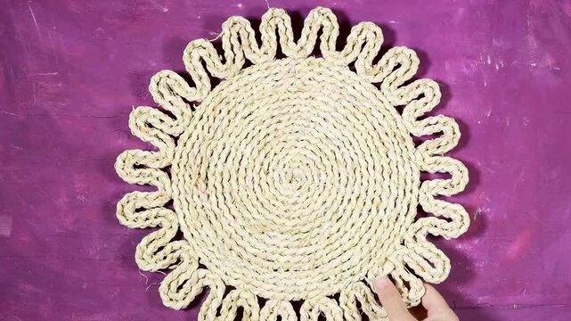 Oriental Algerian sweet cookies named tcharek aryen in arabic which mean almond cookies in english  On Black Plate With Hands, Rustic Woven Mat And White Roses 