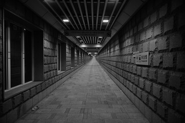 Deserted Brick Corridor with Emergency Bell Sign