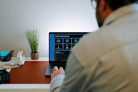 Business professional analyzing colorful sales funnel, ROI, inventory dashboards on laptop - Perfect for SaaS, analytics, fintech, data themes