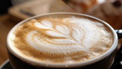 CloseUp of Latte Art Aromatic Coffee with Delicate Heart Design in a Cozy Cafe Setting Perfect for Morning Relaxation and Warmth.