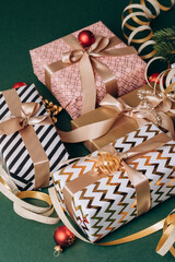 Festive Christmas new year 2026  background with  elegant wrapped gifts and golden decorations on a green background, joyful atmosphere for special occasions