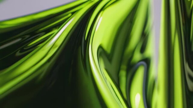 This stunning video showcases the fluid elegance of vibrant green shapes gliding smoothly together. The interplay of light and shadows creates an enchanting visual experience that captivates the viewe