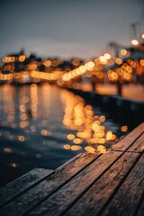Fototapeta premium City lights reflecting on water seen from a wooden pier at night.