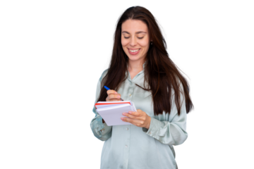 Smiling woman writing personal notes in a spiral notepad, planning tasks and organizing ideas with a pen