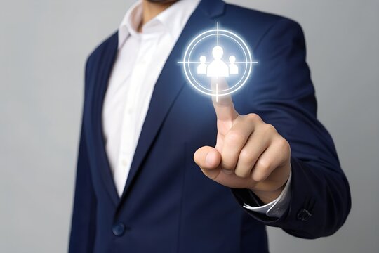 A business professional's finger points towards a glowing digital target with a team icon, symbolizing strategic talent acquisition, recruitment, and focused human resource management