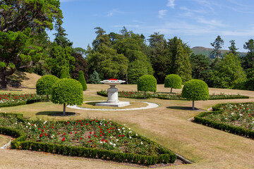 Fototapeta premium a panoramic view over the powerscourt gardens with colorful flowers an vases, ireland