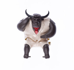 Plastic toy horned bull businessman isolated on white background