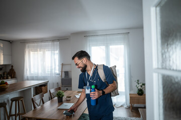 Male healthcare worker preparing to leave home for work