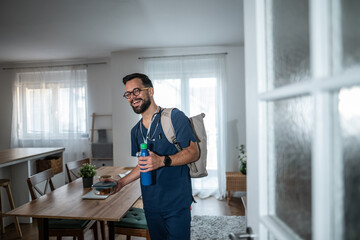 Happy male nurse or doctor leaving home for work