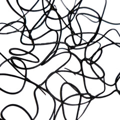 Abstract close-up of tangled black wires or threads creating a chaotic pattern on a white background.