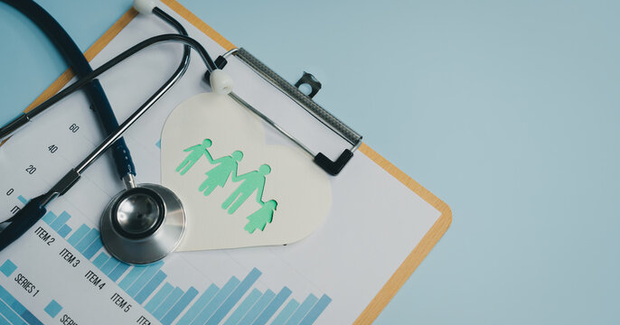 Family health concept with stethoscope and paper cutout of family on clipboard with chart data - Powered by Adobe