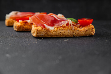 jamon bruschetta prosciutto appetizer portioned tapas dish natural tasty snack fresh delicious gourmet food background on the table rustic top view copy space