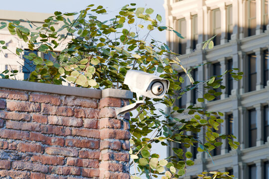 3D eyeball embedded in camera on urban building wall