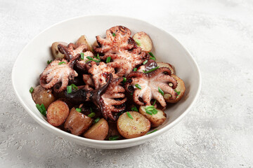 baby grilled octopus with golden baked potatoes and fresh herbs, Maltese cuisine, homemade, no people,