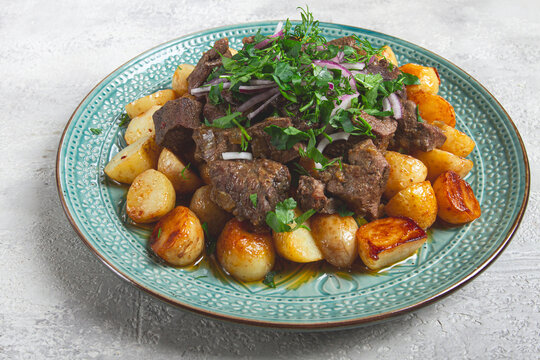 kuyrdak, roast offal with potatoes and fresh herbs, homemade in Kazakh, no people,