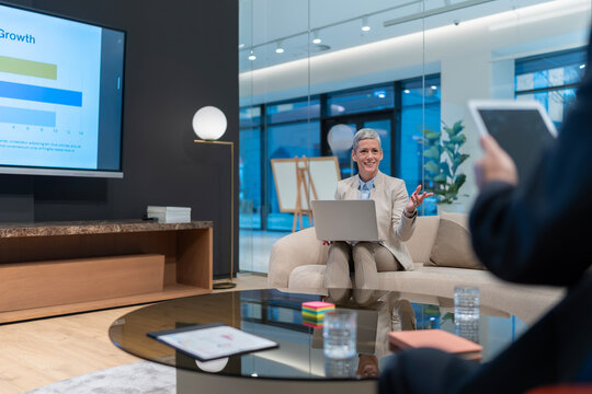 Mature businesswoman presenting business strategy in modern office