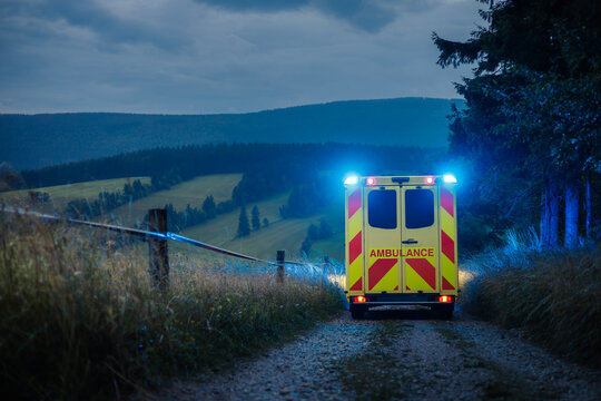 Fototapeta Ambulance car of emergency medical service on mountain road. Themes rescue, urgency and health care.