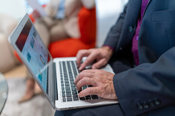 Business professional analyzing data on laptop during meeting