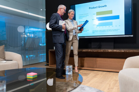 Business colleagues reviewing product growth charts - Powered by Adobe