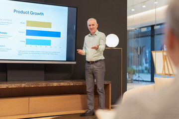 Speaker presenting product growth data in meeting room