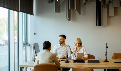 Business meeting in a modern office with diverse team discussing project details