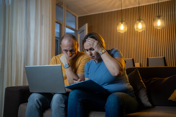 Mature couple calculating their domestic bills at home stock photo