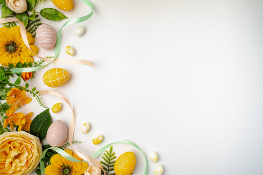 Happy Easter background with easter eggs, ribbons and spring flowers. Easter background with copy space. Flat lay. High quality photo with white background - Powered by Adobe