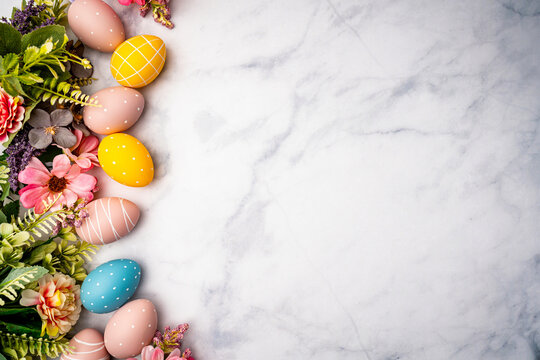 Happy Easter background with easter eggs and spring flowers. Easter background with copy space. Flat lay. High quality photo with marble background