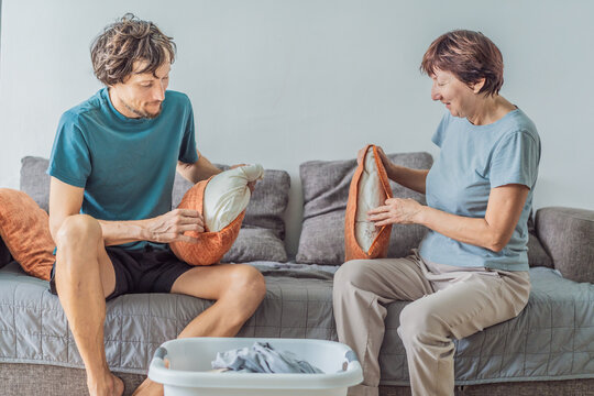 Older woman and her adult son cleaning the house together, sharing teamwork and family cooperation. Home care, organization and lifestyle concept, representing support, connection and everyday - Powered by Adobe