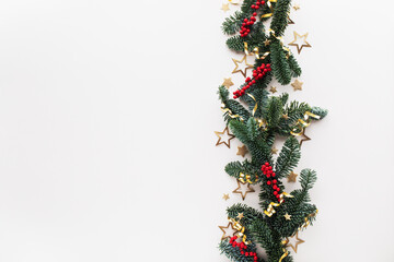 White Christmas background from green fir tree and red ornaments decoration. Festive card border for celebration top view.