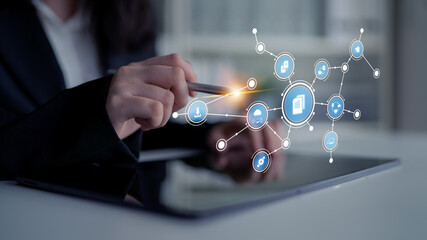 A business professional engages with a tablet, highlighting innovative digital connections and icons that represent technology and communication in a modern work environment. Tessel