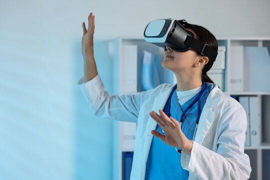 Modern technology. Doctor with headset using virtual screen in office - Powered by Adobe