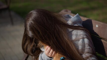 tender pet affection, warm sunlight highlights heartfelt connection between girl and small dog, intimate scene capturing affectionate moment of girl cuddling tiny dog under sunlight on park bench