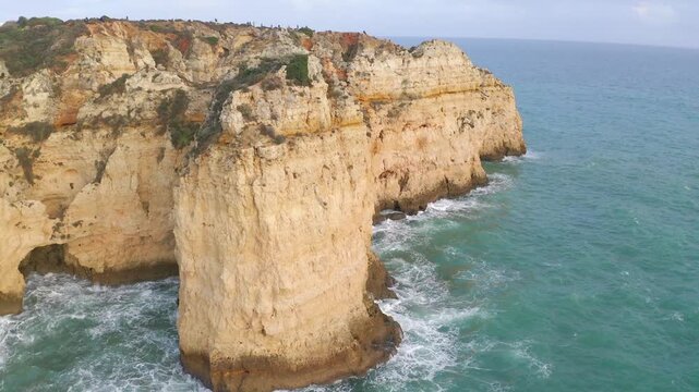 Aerial circling Majestic Coastal Cliffs in Algarve, Portugal Overlooking the Ocean with Turquoise Waters