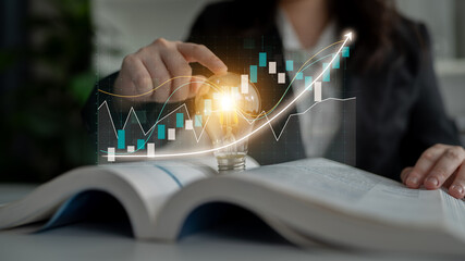 A business professional explores financial data with a light bulb illuminating ideas for innovation, showcasing the importance of creativity in strategic investment decisions. Impute