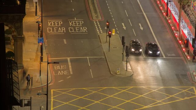 London UK City Intersection at Night with Busy Traffic and Bright Light Trails
