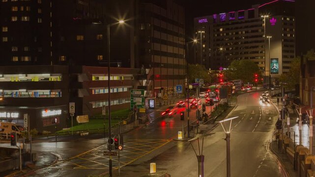 Urban Night Traffic on Well-Lit City Streets with Buildings