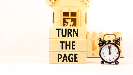 Turn the page symbol. Concept words Turn the page on beautiful wooden block. Black alarm clock. Beautiful white background. Business motivational lifestyle turn the page concept. Copy space.