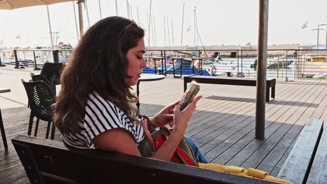 Young Tourist Woman Using Smartphone At Jaffa Port Marina