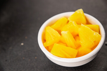 Pineapple canned chunks sweet fruit dessert tasty snack fresh delicious gourmet food background on the table rustic top view copy space keto and paleo diet vegetarian and vegan food