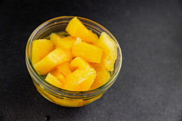 Pineapple canned chunks sweet fruit dessert tasty snack fresh delicious gourmet food background on the table rustic top view copy space keto and paleo diet vegetarian and vegan food