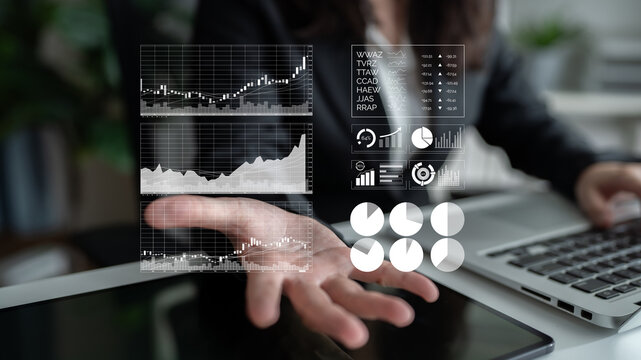 A professional setting showcasing hands-on data visualization with stock market charts and graphs, emphasizing critical insights and strategic business analysis. Impute - Powered by Adobe