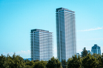 Fototapeta premium Modern skyscraper tower buildings on a sunny summer day with a grainy texture