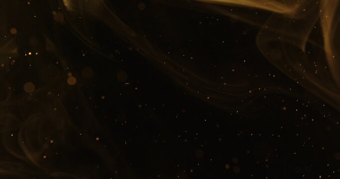 Abstract particles of gold dust float in the air